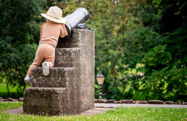 Young child climbing on canon in Tamworth Castle Pleasure Grounds
