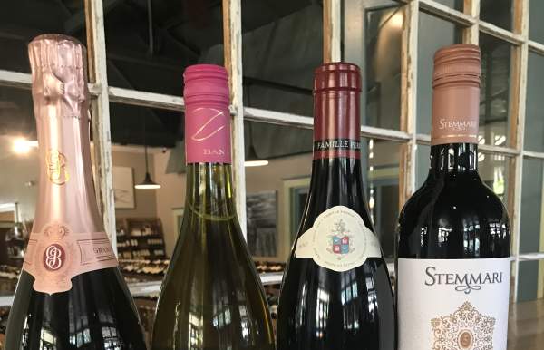 Red or White wine tasting four bottles of different wines side by side on a table
