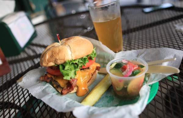 Bacon Cheeseburger, pickle spear, cup of tomato and cucumber salad