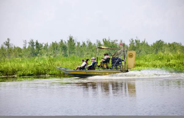 People riding in an airboat in the Mobile Bay