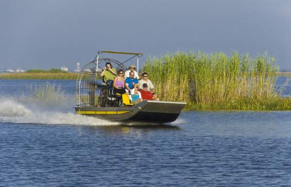 group of people riding on an airboat