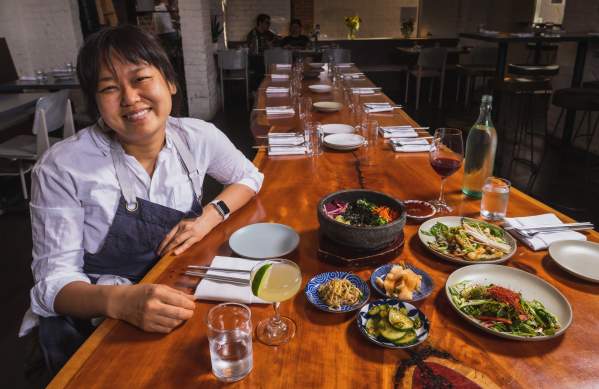 Chef Ji Hye Kim at a table of Korean food