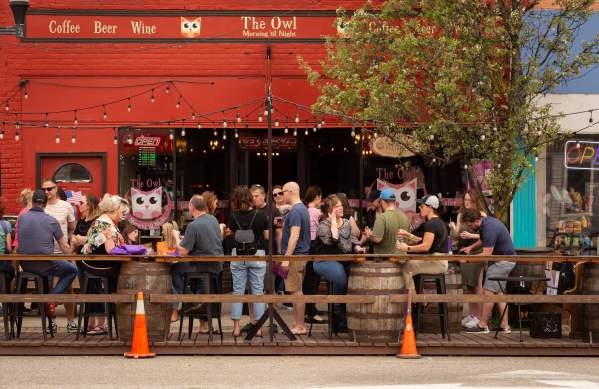 People dining outdoors at The Owl in Milan, MI