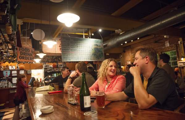 Couple having drinks at the bar at Arbor Brewing Company in Ypsilanti