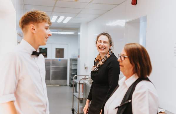 Smiling hotel staff at Petwood Hotel in kitchen
