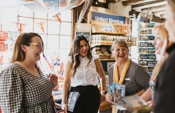 A group of women in conversation, laughing together