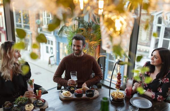 A group of friends enjoying tapas and drinks at the Botanist