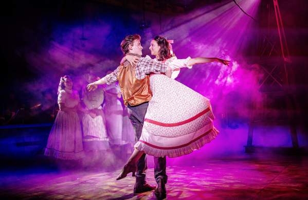 Man and woman dancing on stage during a production of Oklahoma