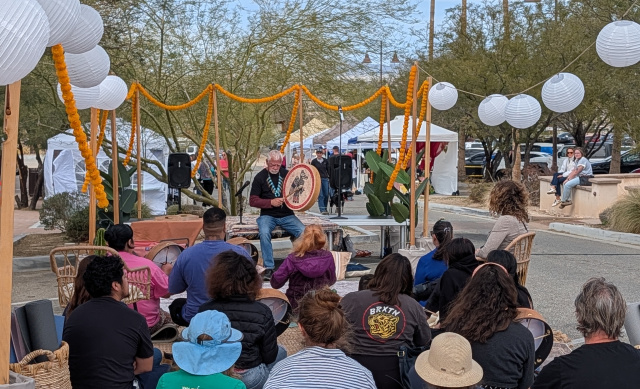 Attendees watching a drum performance at the Holistic Health Fair at the Historic Plaza in Twentynine Palms, California.
