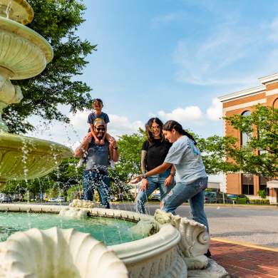 family by a downtown fountain