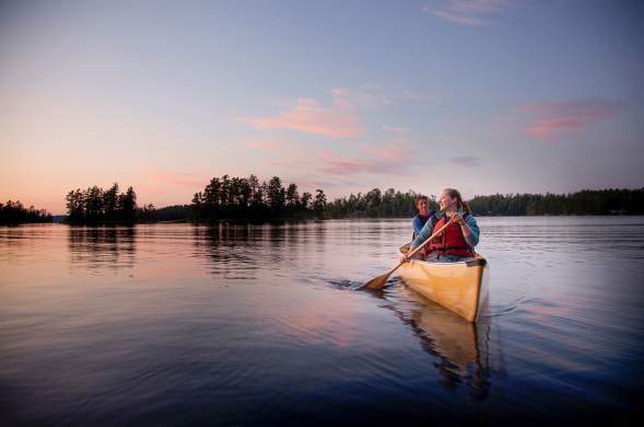Two people canoeing on an inland lake