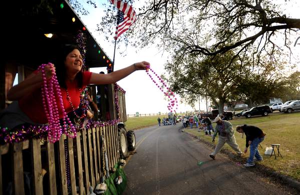 Women throwing Mardi Gras beads
