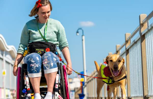A wheelchair user and their dog on the Grand Pier at Weston-super-Mare near Bristol - credit The Grand Pier