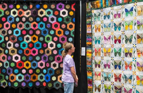 Woman looking at quilts during the Tulip Time Quilt Show