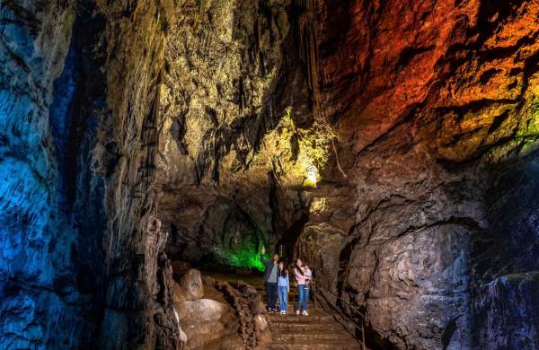 A family in a cave at Wookey Hole near Bristol - credit Wookey Hole