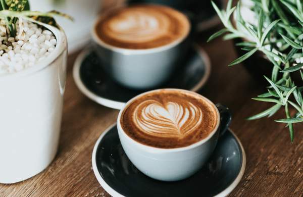 A coffee cup with latte art on a table