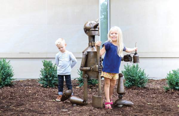 Children climbing on Bronze statue of the Tin Man