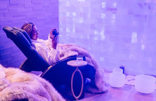 Women lounging in halotherapy salt room. Using digital camera.