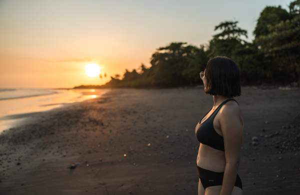 Woman enjoy sunset at Cerro Hoya beach in Los Santos