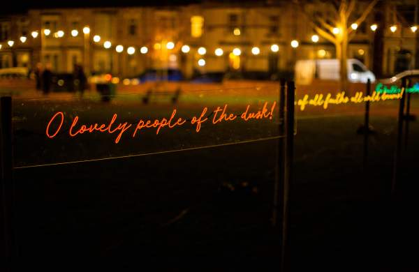 A light installation of glowing handwritten text