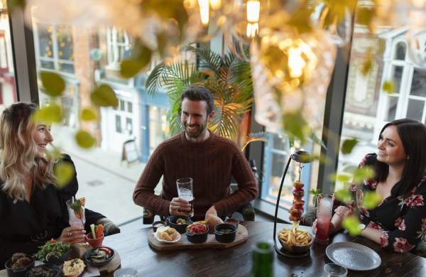 A group of friends enjoying tapas and drinks at the Botanist