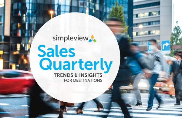 People walking through a crosswalk with the Simpleview Sales Quarterly logo in the forefront.