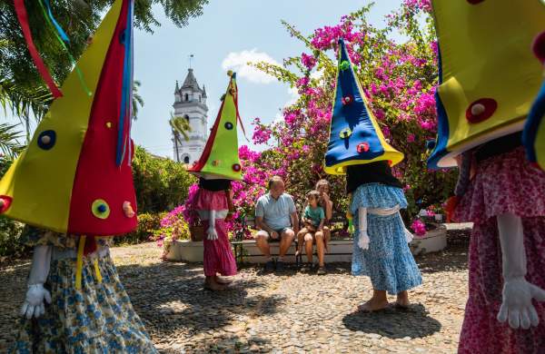 A festive occasion characterized by people donning costumes of small individuals with oversized headwear at la Villa de Los Santos
