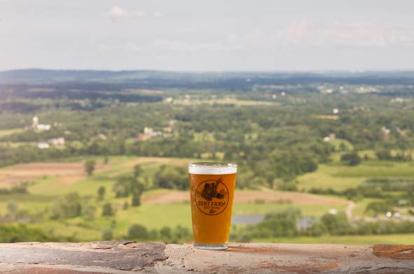 Pint of beer from Dirt Farm overlooking valley.
