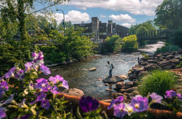 Couple over river rocks fishing