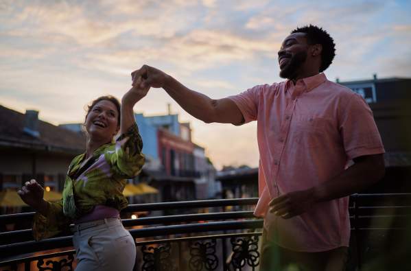 A couple dances on a French Quarter balcony