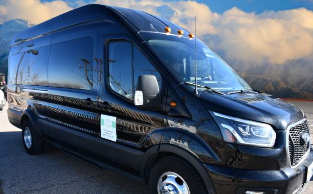Black shuttle van with cottonwood connect logo on the side
