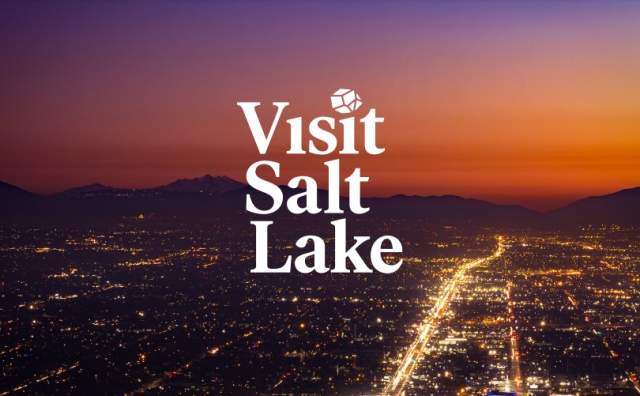 Sunset overhead view of the Salt Lake Skyline with the words Visit Salt Lake and Meeting Planner's Guide Book