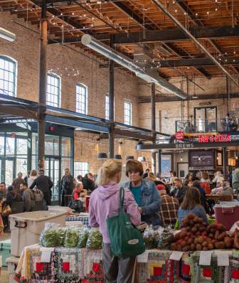 A wide view of vendors and shoppers at the Late Winter Farmers' Market at Garver Feed Mill