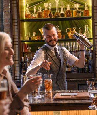 2 women enjoy drinks at the Harvey House bar