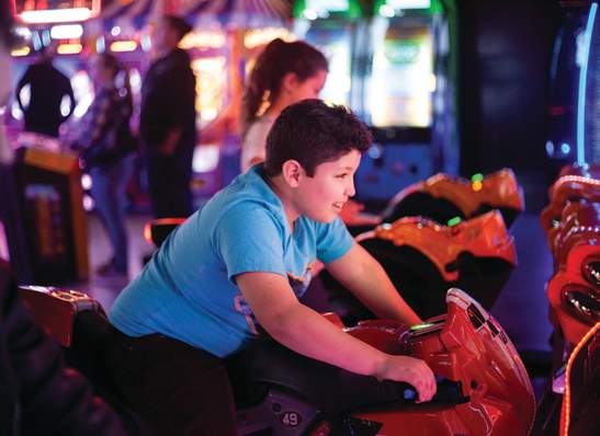 boy playing in an arcade