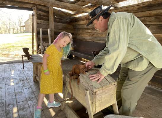 girl at a demonstration about pioneer life