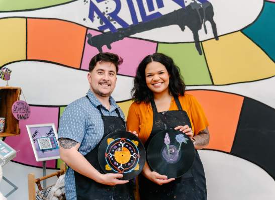 couple posing with painted vinyl records