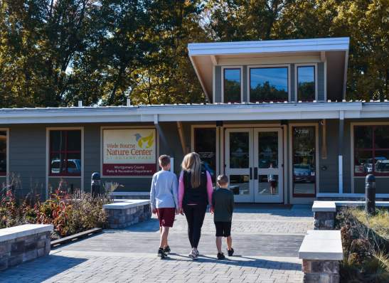 family walking into a nature center