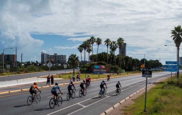 Bikes Passing Welcome Sign