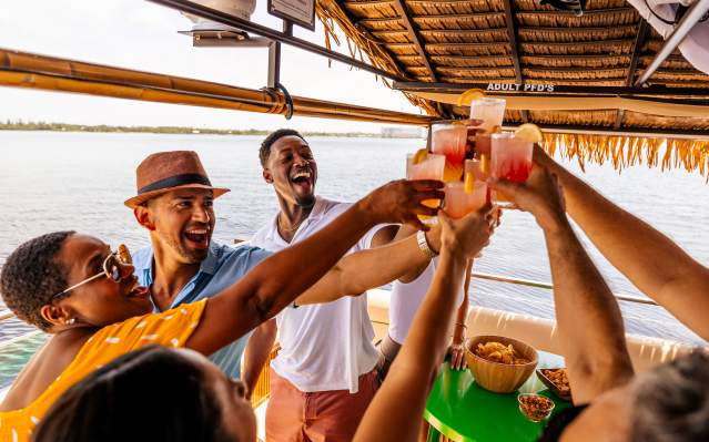 Friends toasting aboard the Oasis Tiki Boat in Charlotte Harbor, Florida