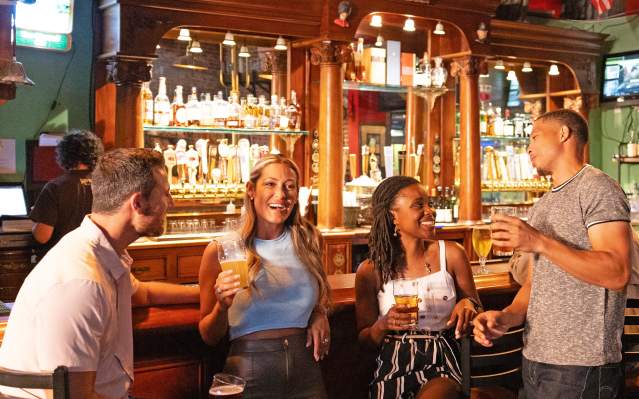 Four friends enjoying a drink at the bar at IceHouse Pub in Punta Gorda, Florida