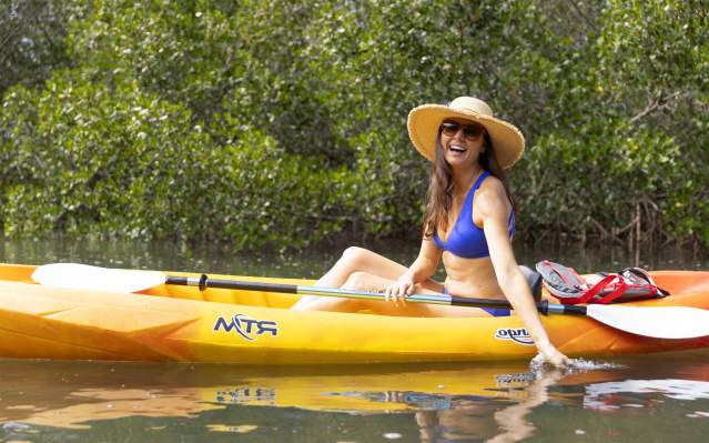 Woman kayaking mangrove tunnels in Punta Gorda/Englewood Beach