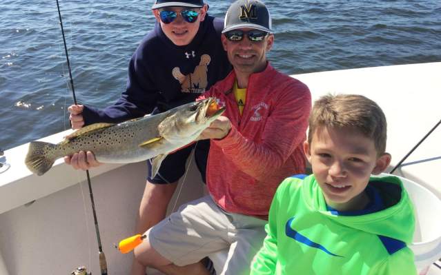 Fun family fishing: showing off a speckled trout caught in Punta Gorda/Englewood Beach
