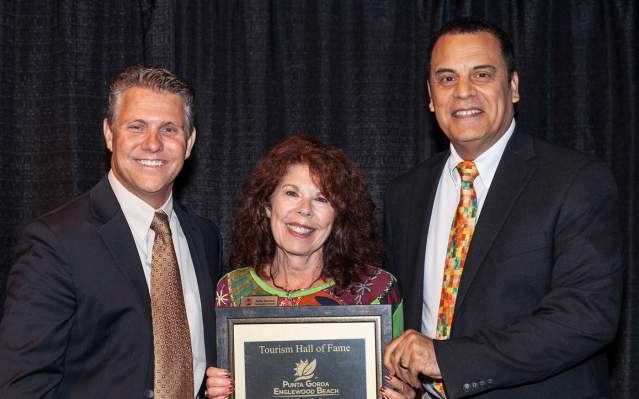 2022 Tourism Hall of Fame Winner Kathy Burnam, accepting her award from Tourism Director Sean Doherty and County Commissioner Christopher Constance