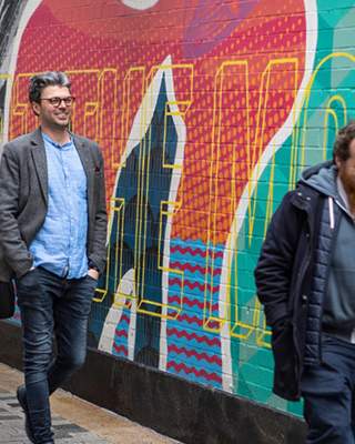 Group enjoying a street art walking tour with Seedhead Arts