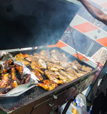A grillmaster attends to some jerk chicken at Blues, Brews, and BBQ event in Allentown, Pa.