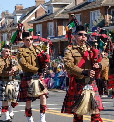 Bagpipers playing and marching in the Allentown St. Patrick's Day parade.