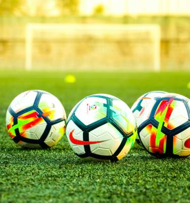 Soccer balls on a soccer field.