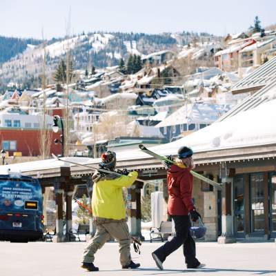 Skiers walking by old town transit station