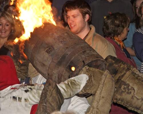 people taking part in tar barrel rolling